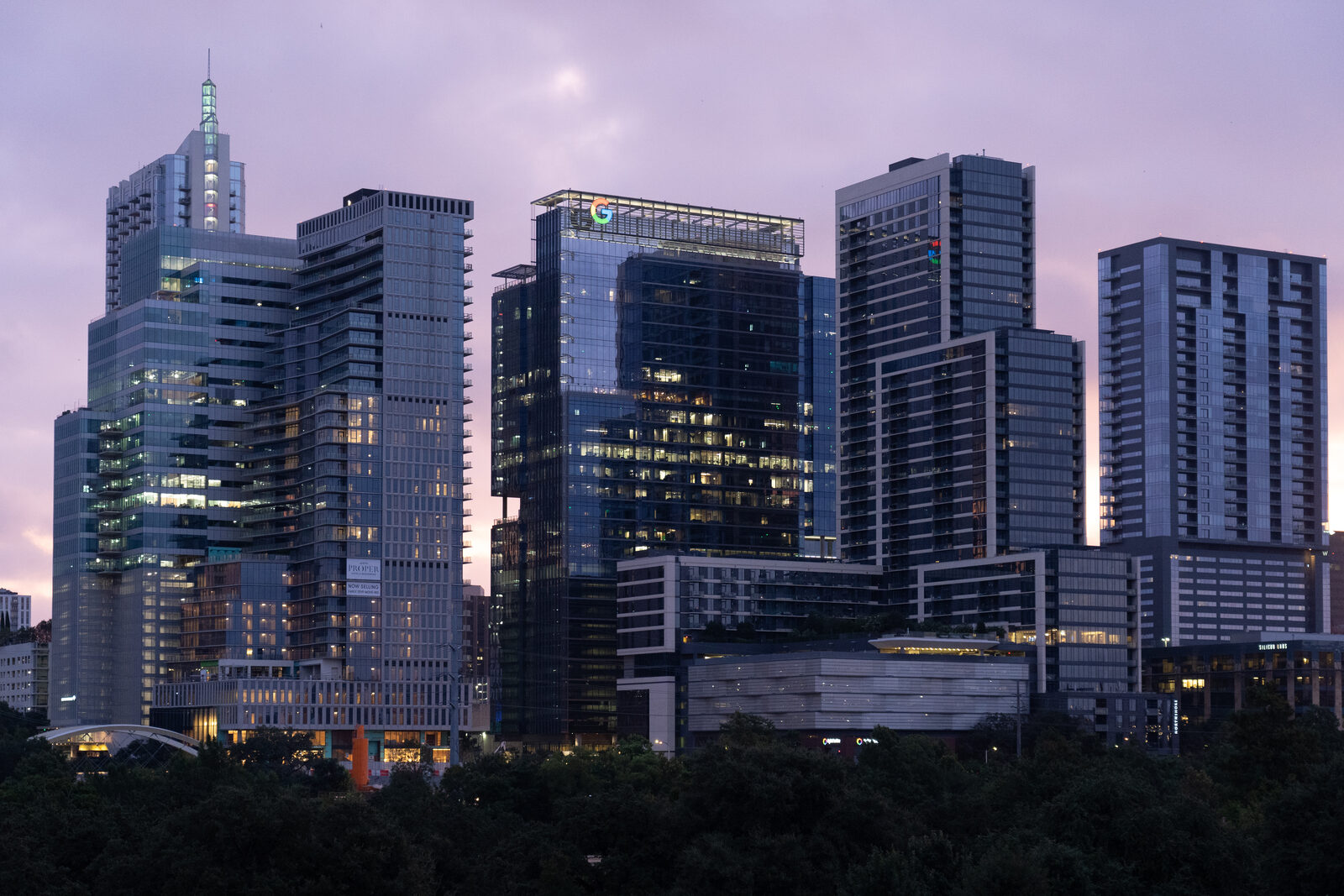 Downtown Austin office towers lit at the start of the workday